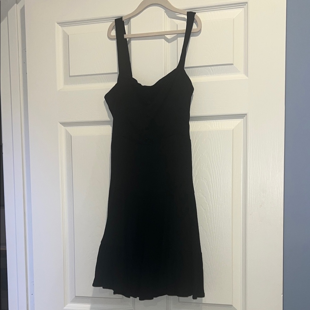 Forever 21 Black sleeveless mini dress. Lined with a peplum back button details.